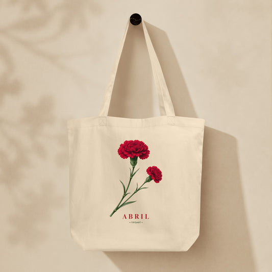 Sac tote crème oyster suspendu sur mur, œillet rouge et bouton sur tige, texte Abril, série Œillets 25 avril Portugal TifoArt